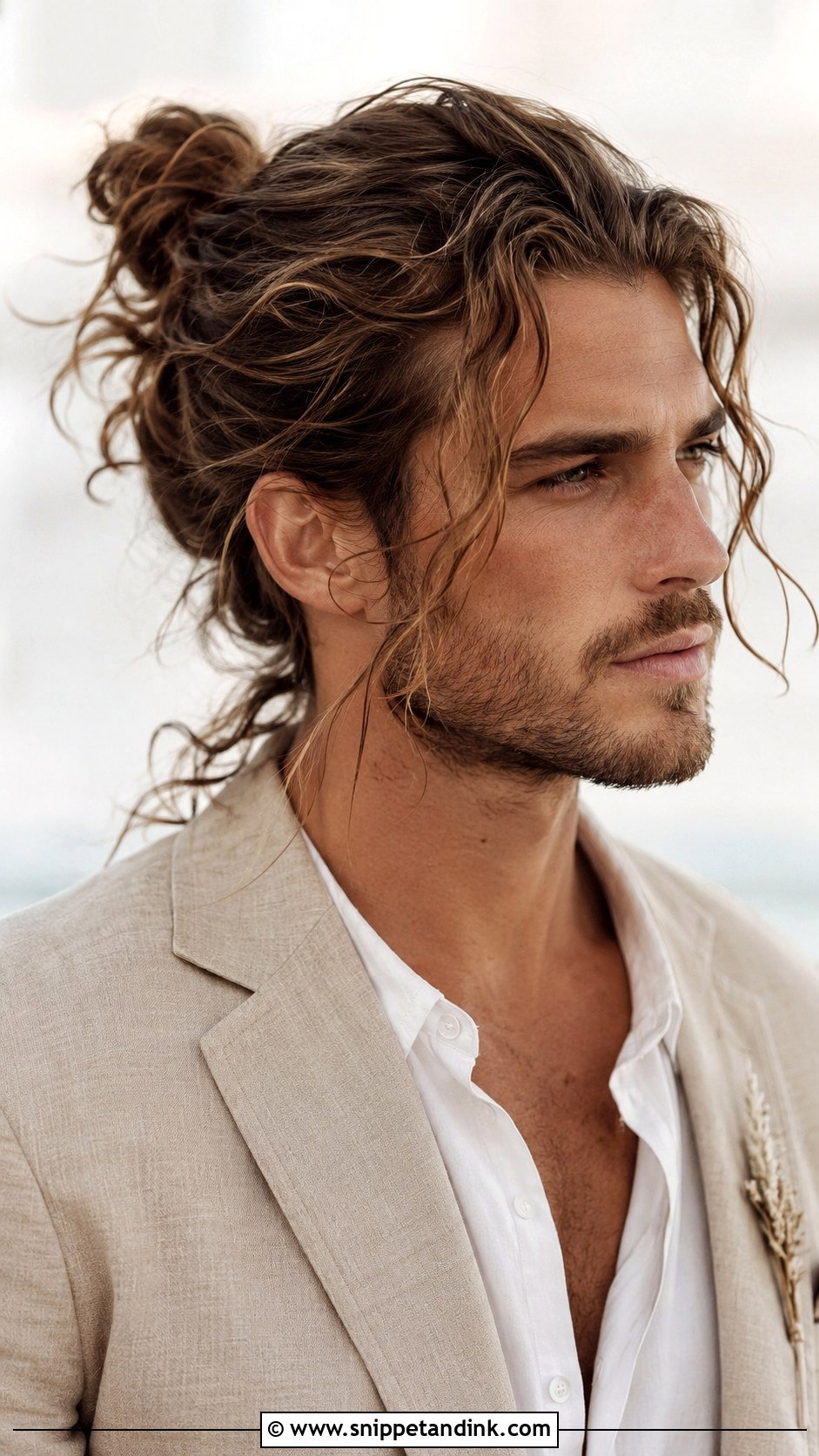 Boho Bun with Loose Strands - Snippet and Ink - 20 Long Hair Groom Ideas
