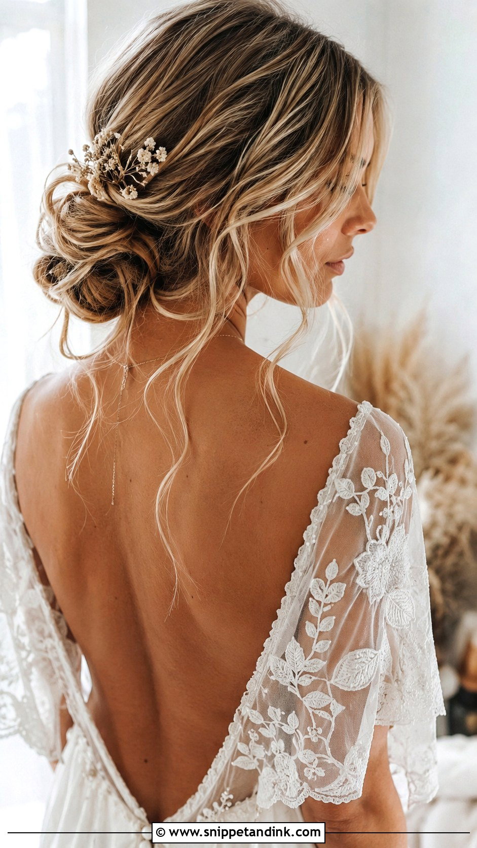 Boho Low Bun With Loose Waves - Snippet and Ink - 20 Low Loose Bun Wedding Ideas