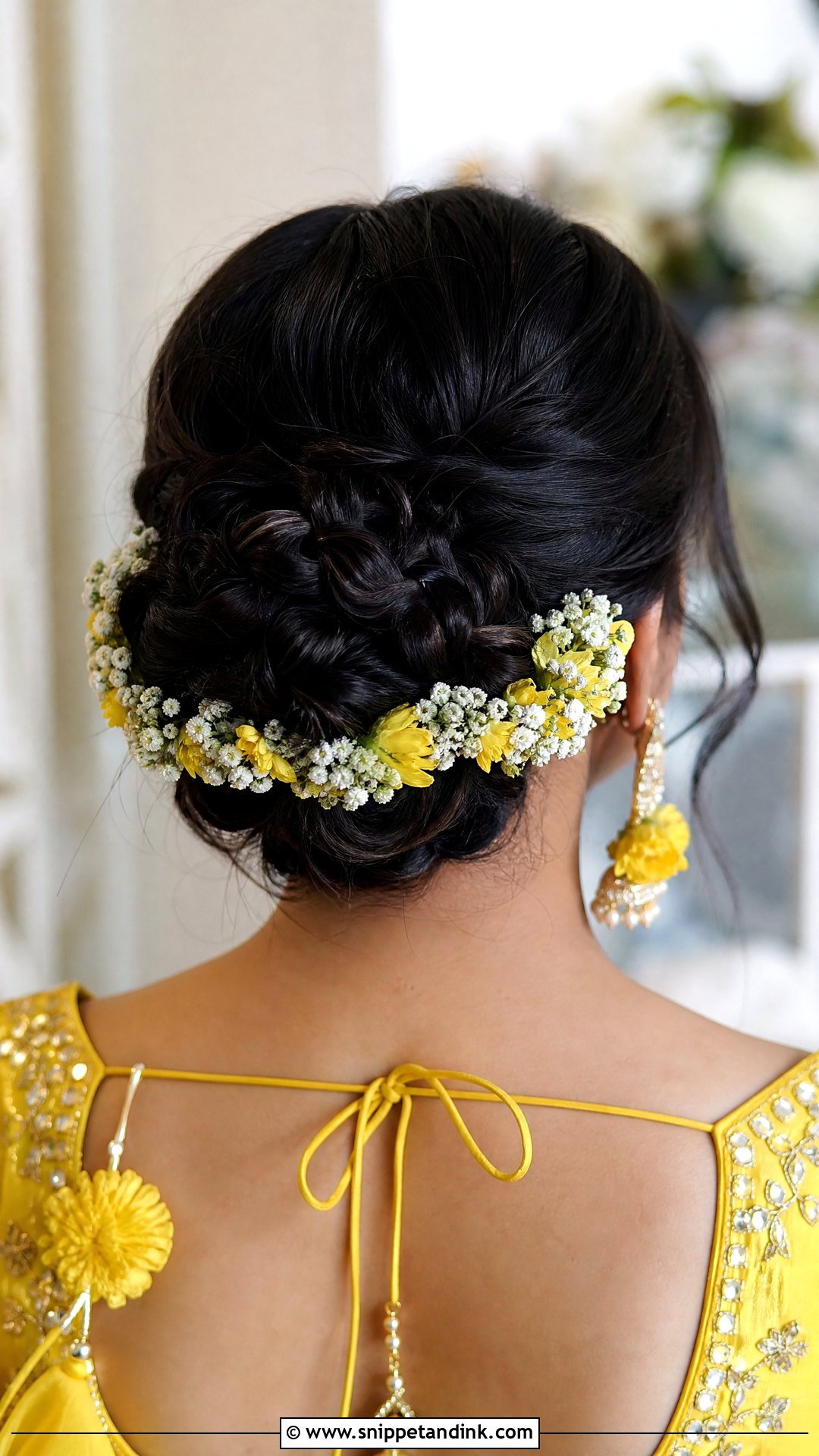 Braided Bun With Floral Accents - Snippet and Ink - 20 Hairstyle for Haldi Bride Ideas