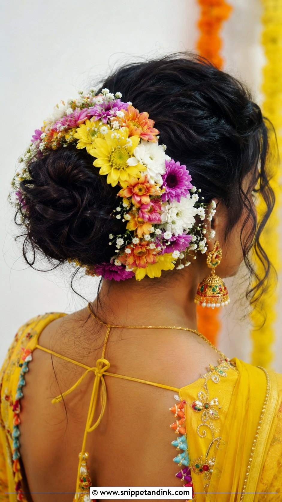 Bun With Multicolor Flowers - Snippet and Ink - 25 Indian Wedding Bun Hairstyles