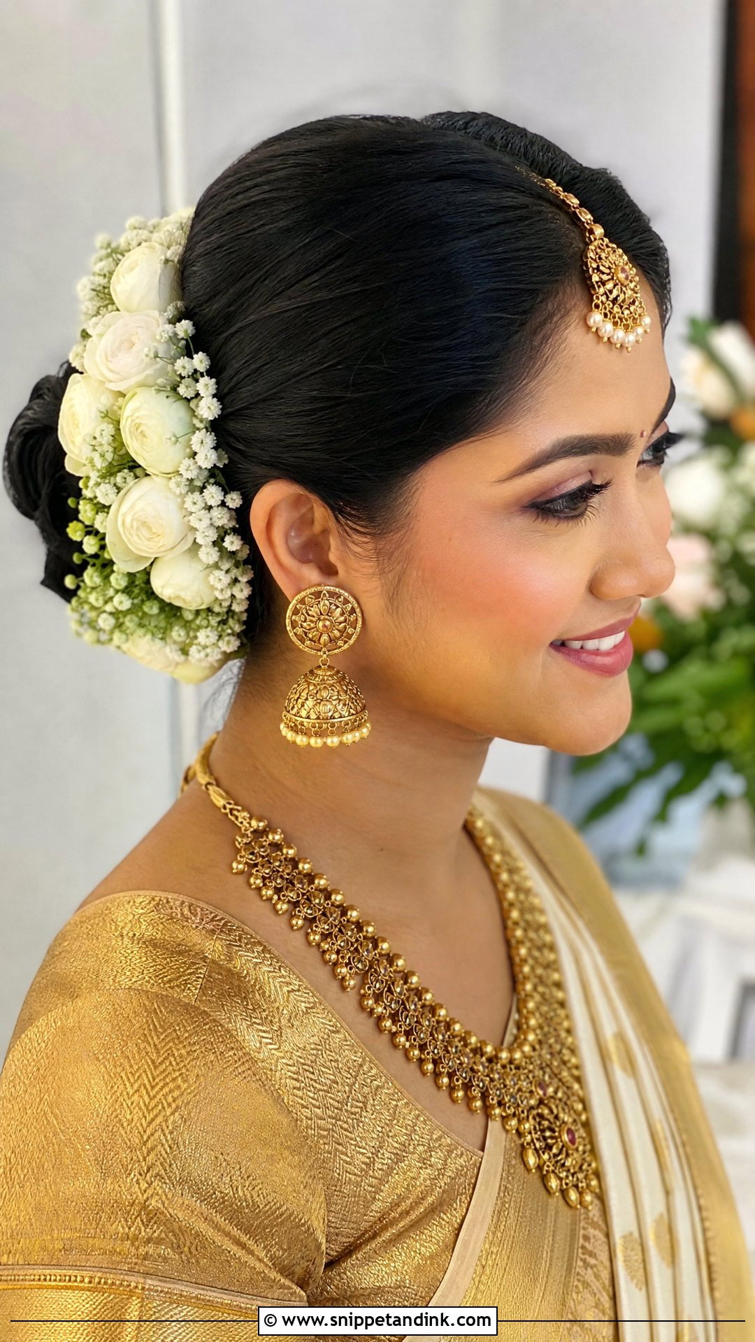 Crescent Floral Bun - Snippet and Ink - 20 Mandap Hairstyle for Bride Ideas