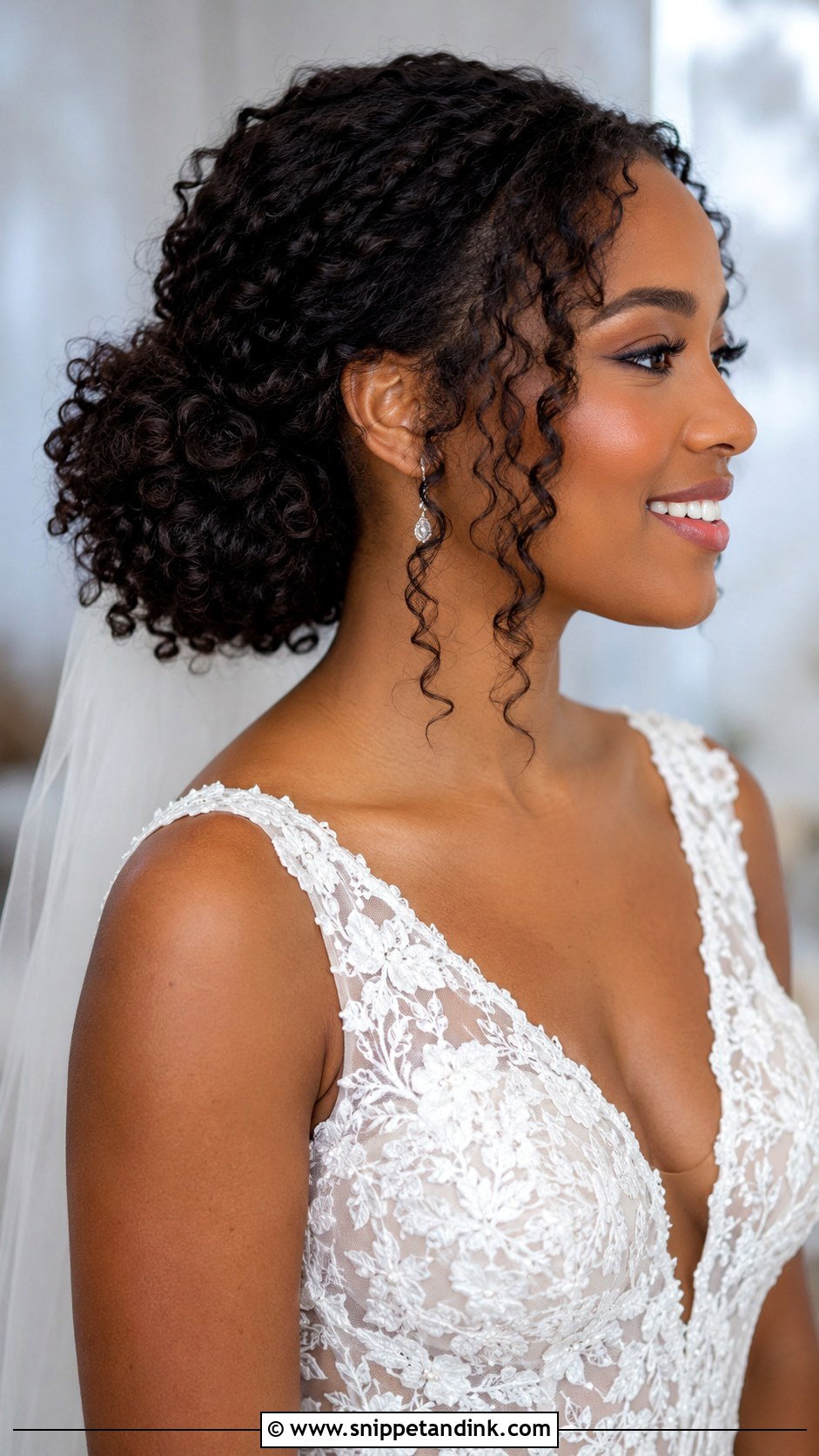 Curly Bridal Bun With Face Framing Tendrils - Snippet and Ink - 20 Natural Hairstyles for Brides