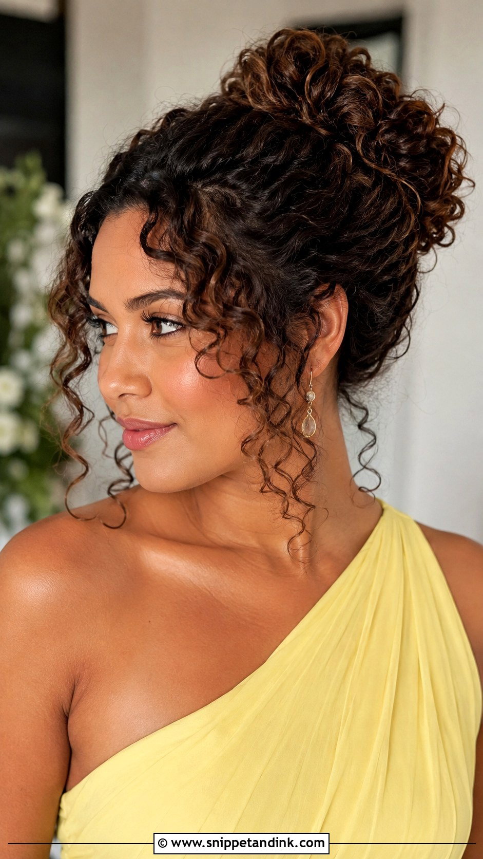 Curly Bun With Face Framing Pieces - Snippet and Ink - 20 Curly Hairstyle for Wedding Guest Ideas