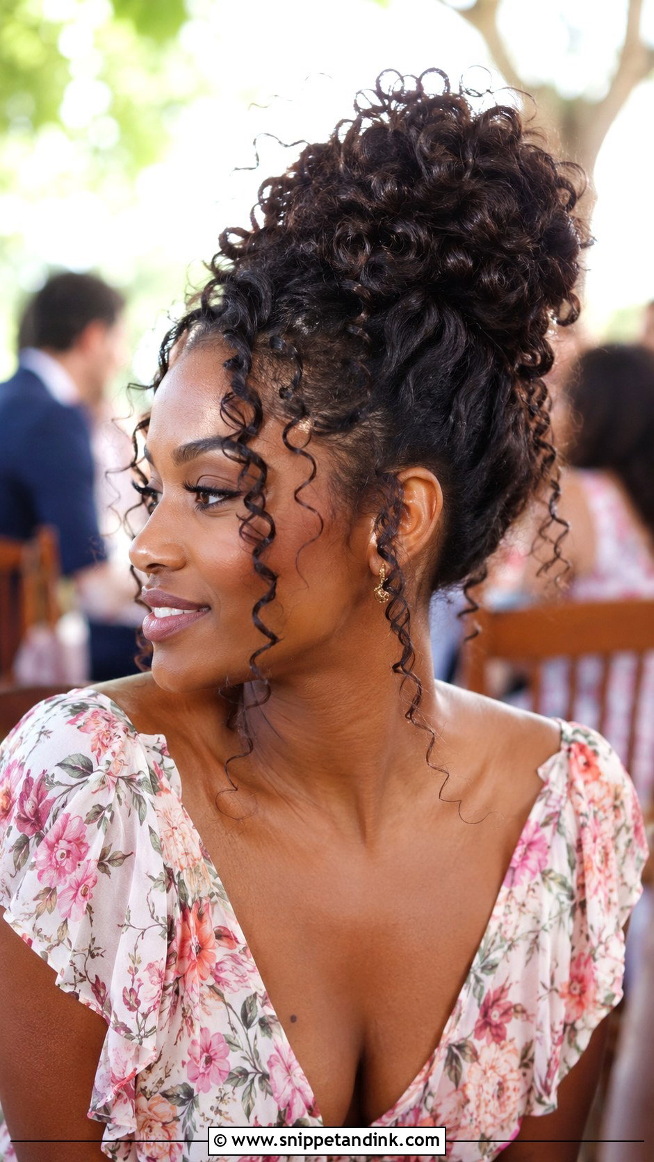 Curly Bun With Loose Tendrils - Snippet and Ink - 20 Wedding Guest Bun Hairstyles