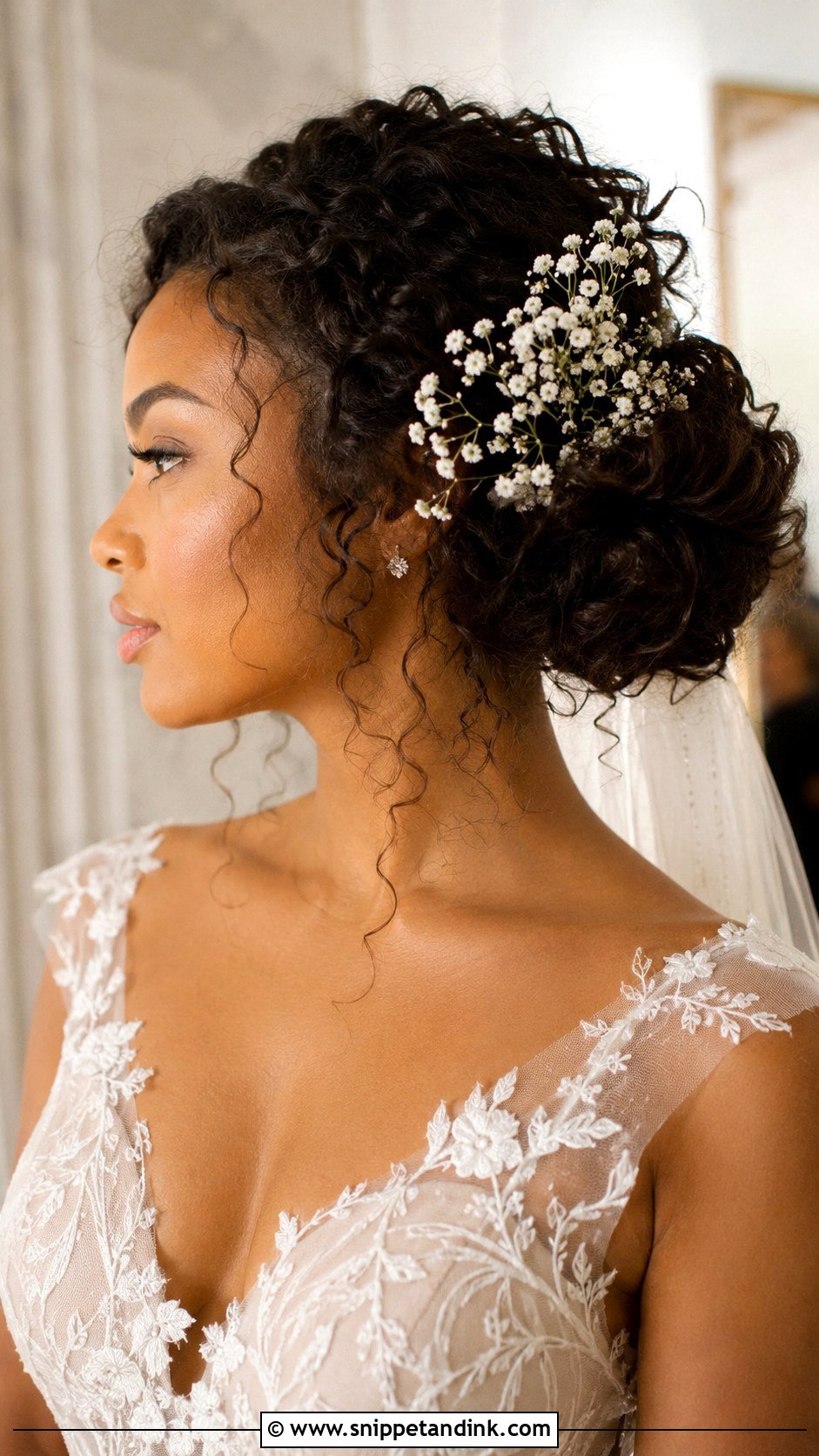 Curly Low Bun With Babys Breath - Snippet and Ink - 20 Natural Hairstyles for Brides
