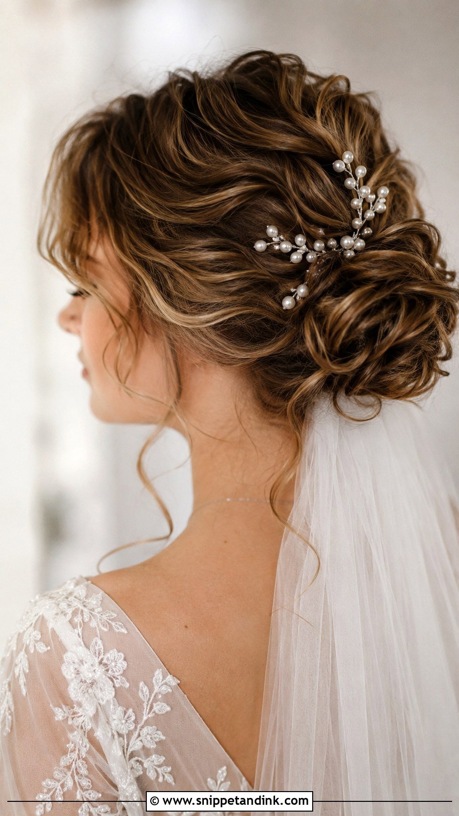 Curly Low Bun With Pearls - Snippet and Ink - 20 Short Curly Wedding Hairstyles