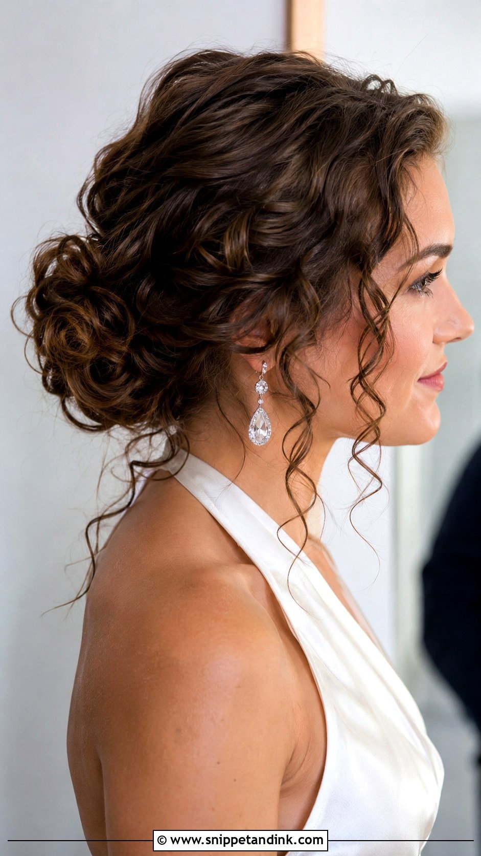 Curly Low Bun With Tendrils - Snippet and Ink - 20 Bride with Curly Hair Ideas