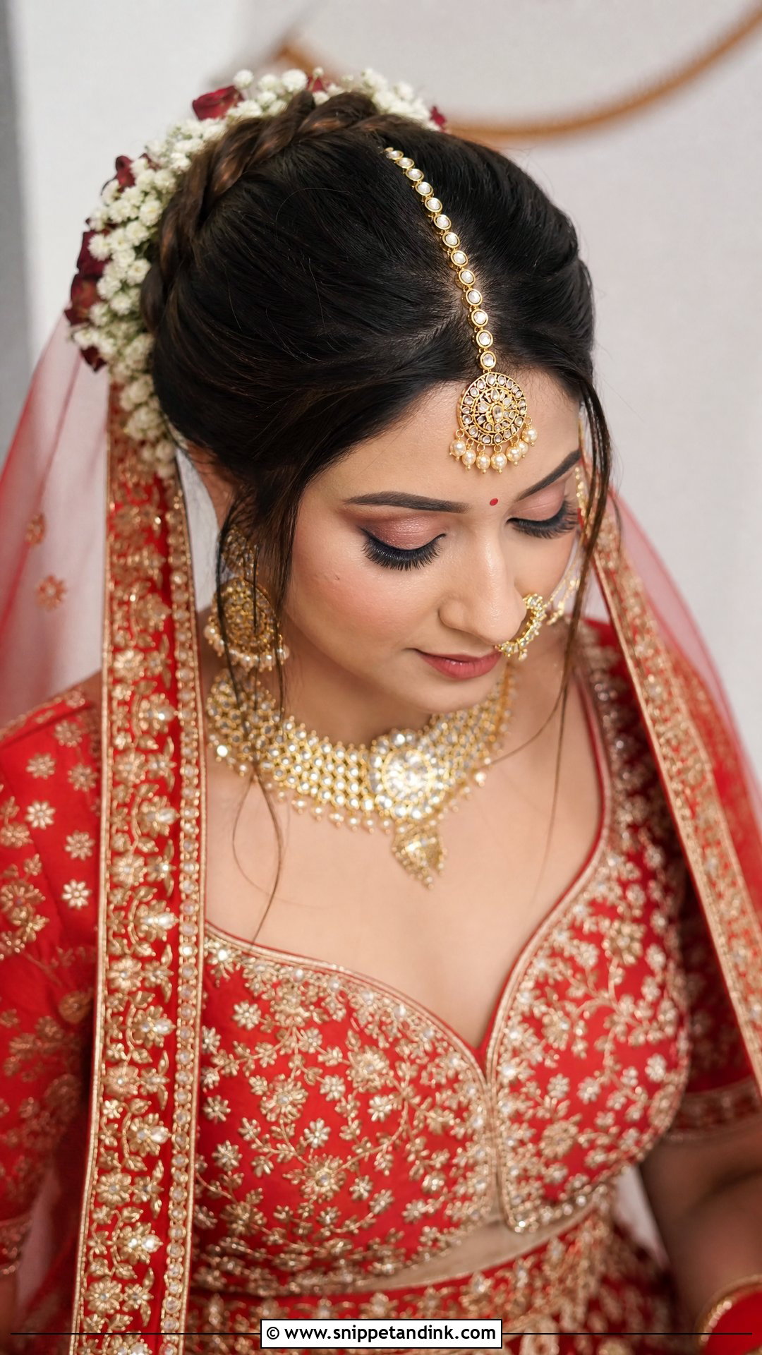 Floral Bun With Maang Tikka and Veil - Snippet and Ink - 20 Traditional Indian Wedding Hairstyles