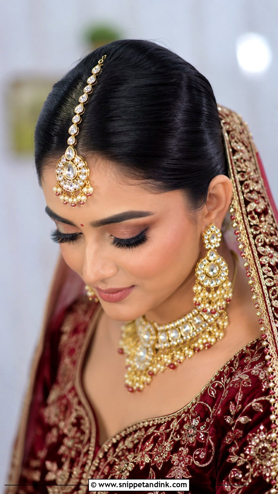 Indian Bridal Sleek Bun With Heavy Maang Tikka - Snippet and Ink - 15 Indian Bridal Hairstyle for Big Forehead Ideas