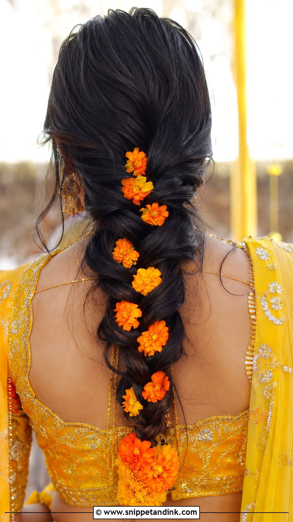 Loose French Braid With Marigold - Snippet and Ink - 25 Haldi Ceremony Hairstyle for Bride Ideas