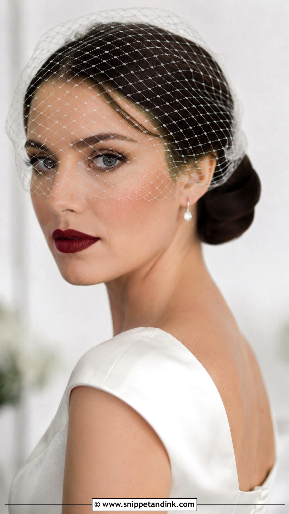 Low Bun With Birdcage Veil - Snippet and Ink - 30 Low Updo Wedding Hair Ideas