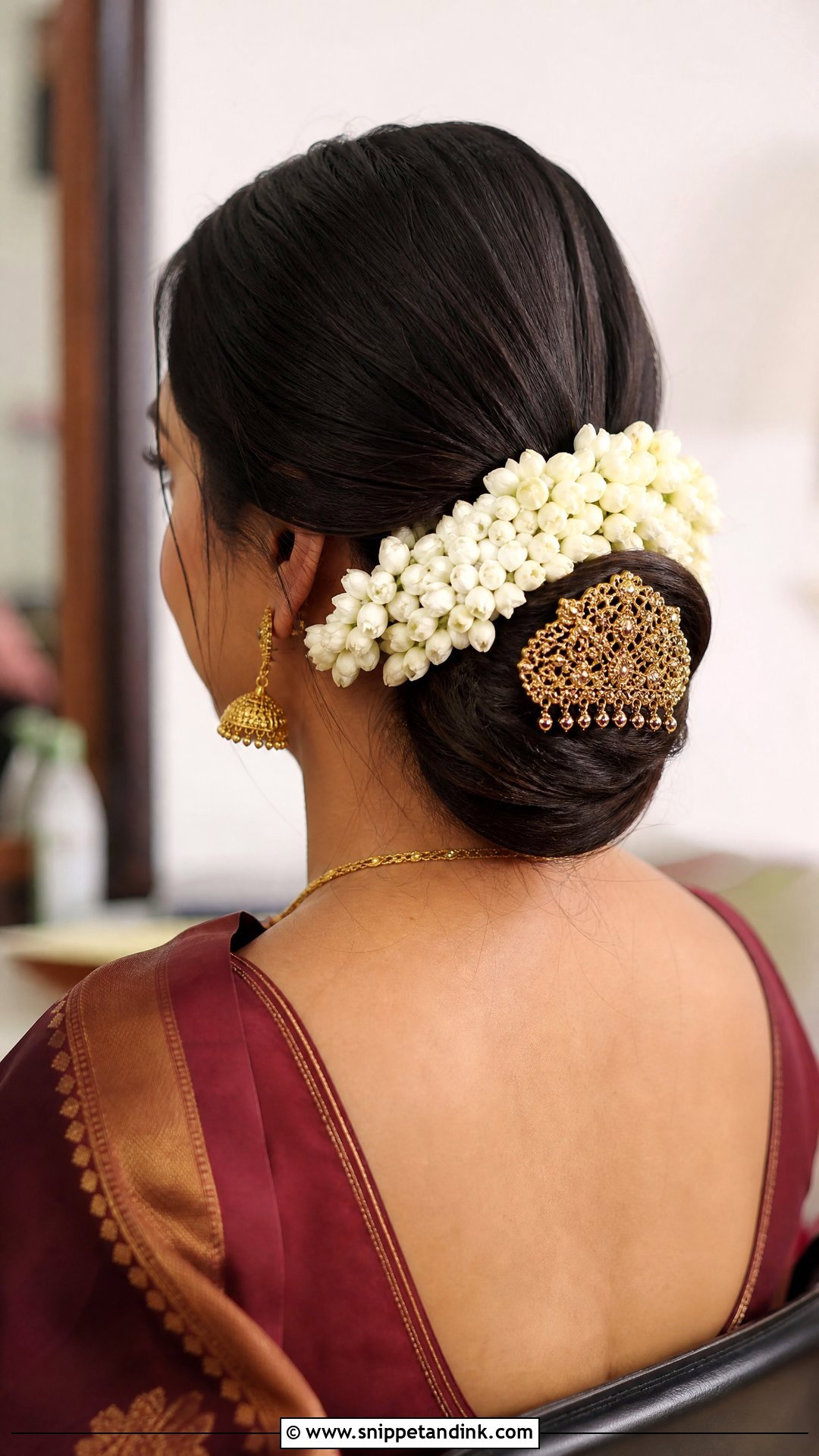 Low Bun With Center Part - Snippet and Ink - 20 South Indian Wedding Bridal Hairstyle Ideas