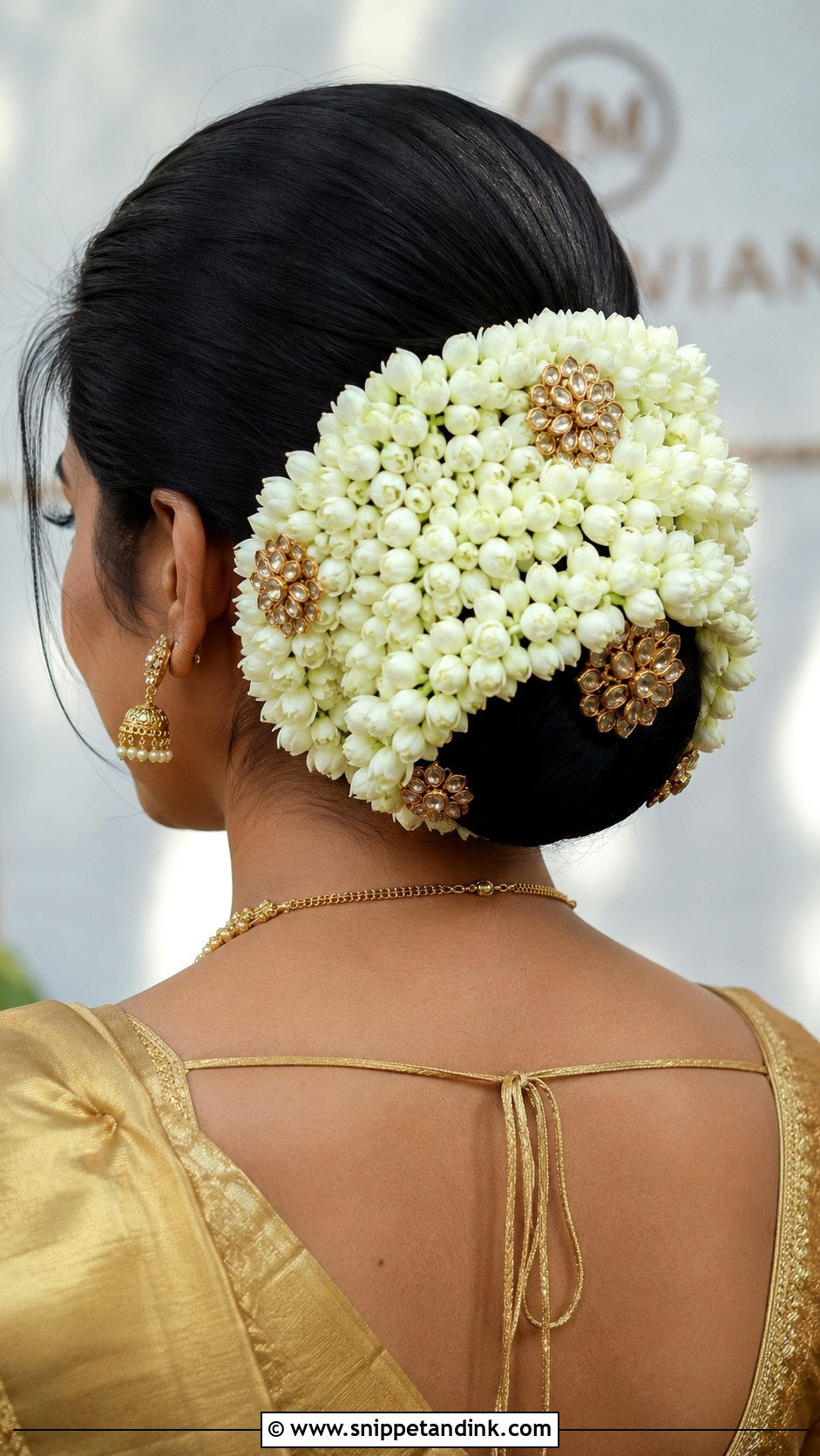 Low Bun Wrapped In Jasmine Gajra - Snippet and Ink - 20 South Indian Bride Hairstyle with Jasmine Flowers