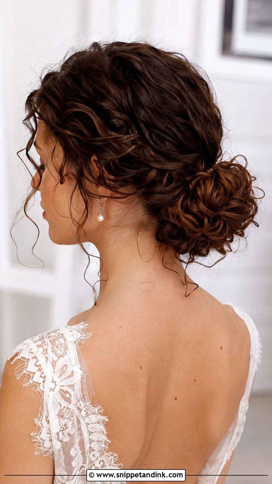 Low Curly Bun with Face Framing Tendrils - Snippet and Ink - 25 Curly Updo Hairstyles for Wedding