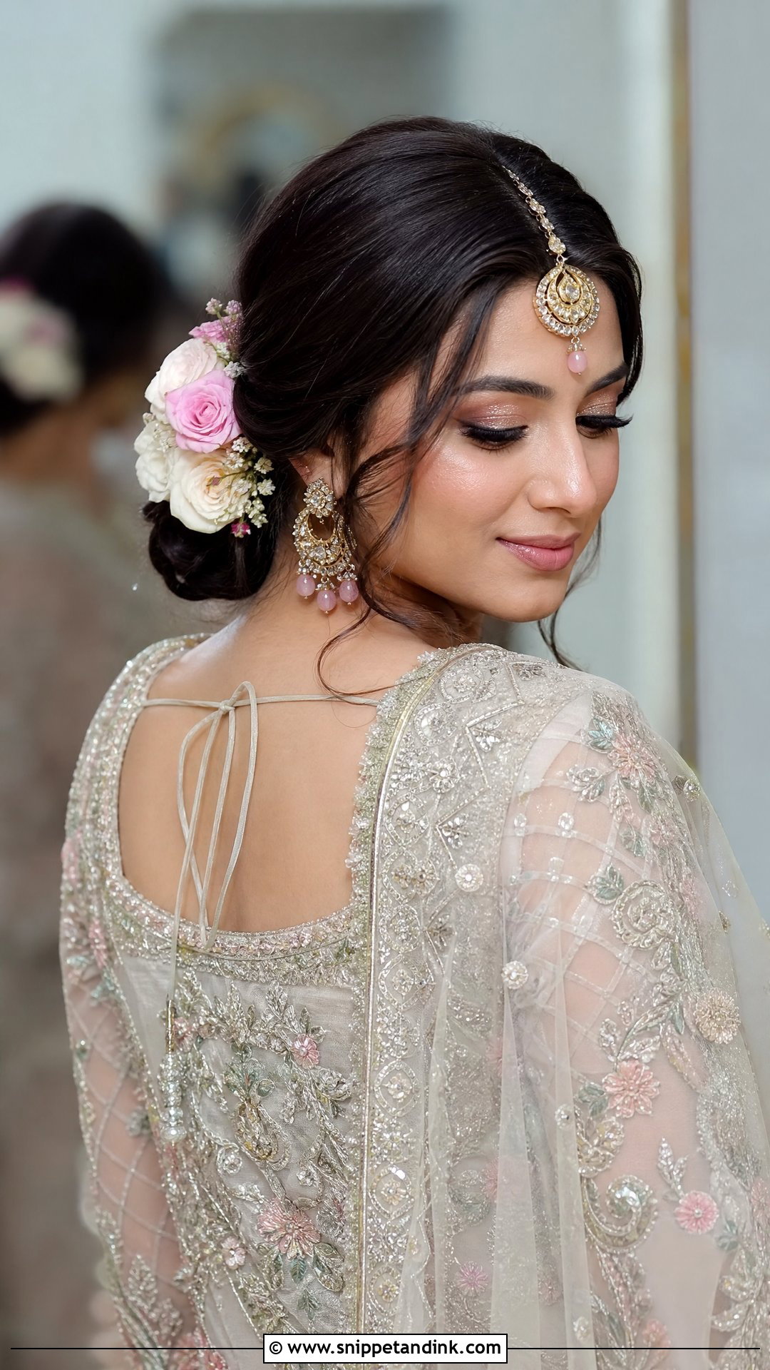 Low Floral Bun With Maang Tikka - Snippet and Ink - 20 Pakistani Bridal Hairstyles Nikah