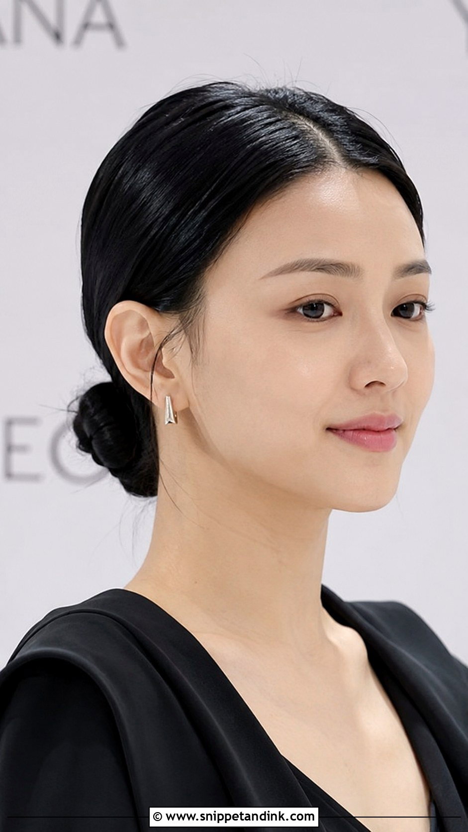 Low Knotted Bun With Center Part - Snippet and Ink - 20 Medium Length Hairstyles for Wedding Guest
