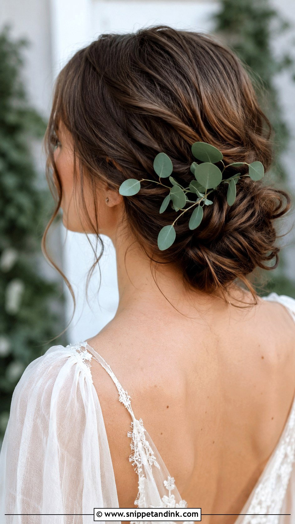 Low Messy Bun With Greenery - Snippet and Ink - 30 Low Messy Bun Wedding Hair Ideas