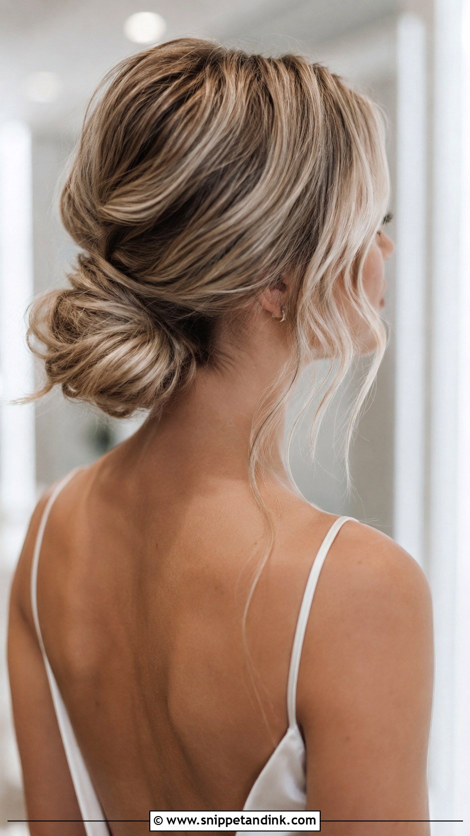 Low Messy Bun With Loose Strands - Snippet and Ink - 30 Boho Bridal Hair Ideas