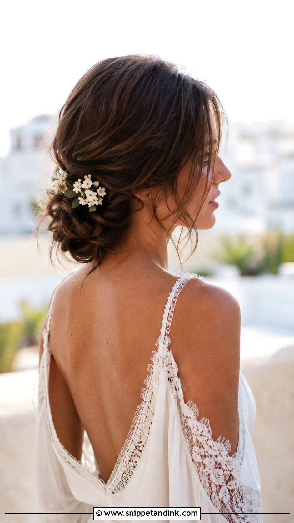 Low Messy Bun With Loose Strands - Snippet and Ink - 20 Hippie Wedding Hair Ideas