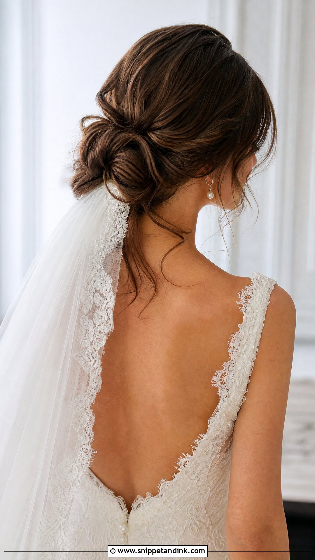 Low Messy Bun With Veil - Snippet and Ink - 20 Messy Bridal Bun Ideas