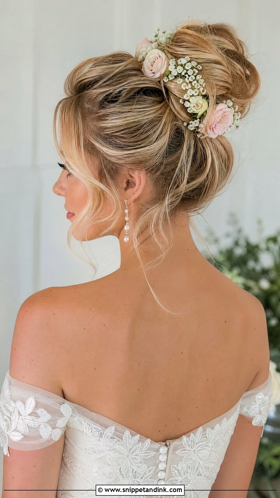 Low to High Bun With Flowers - Snippet and Ink - 20 High Bun for Wedding Ideas