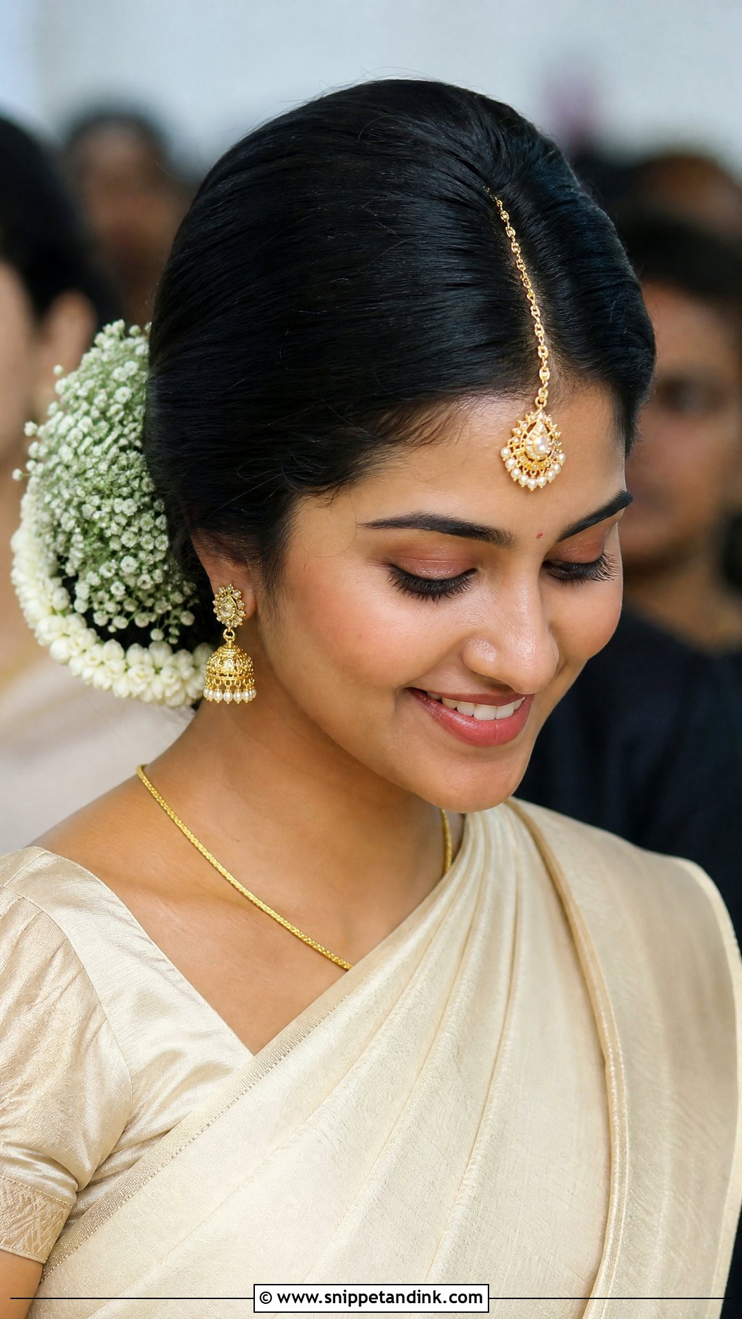 Maang Tikka Low Bun With Babys Breath - Snippet and Ink - 20 Tamil Wedding Hairstyle Ideas