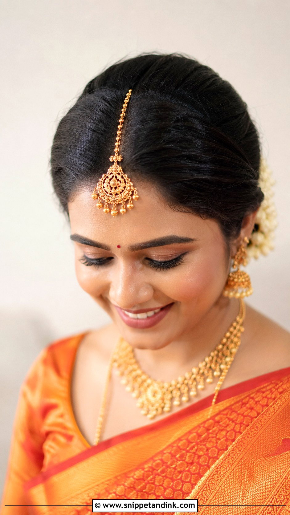 Maang Tikka Updo for Muhurtham - Snippet and Ink - 25 South Indian Bride Muhurtham Hairstyle Ideas