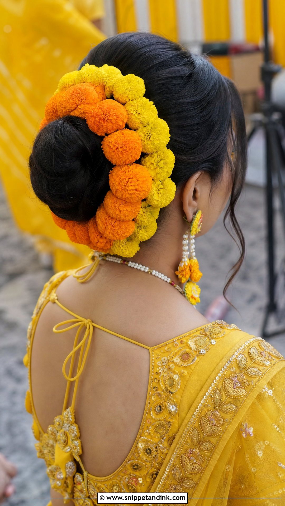 Marigold Bun for Haldi Ceremony - Snippet and Ink - 20 Indian Wedding Bun Bridal Hairstyle Ideas