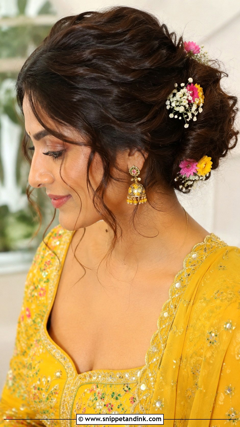 Messy Bun With Loose Tendrils for Mehendi - Snippet and Ink - 25 Traditional Indian Weddings Bridal Hairstyles