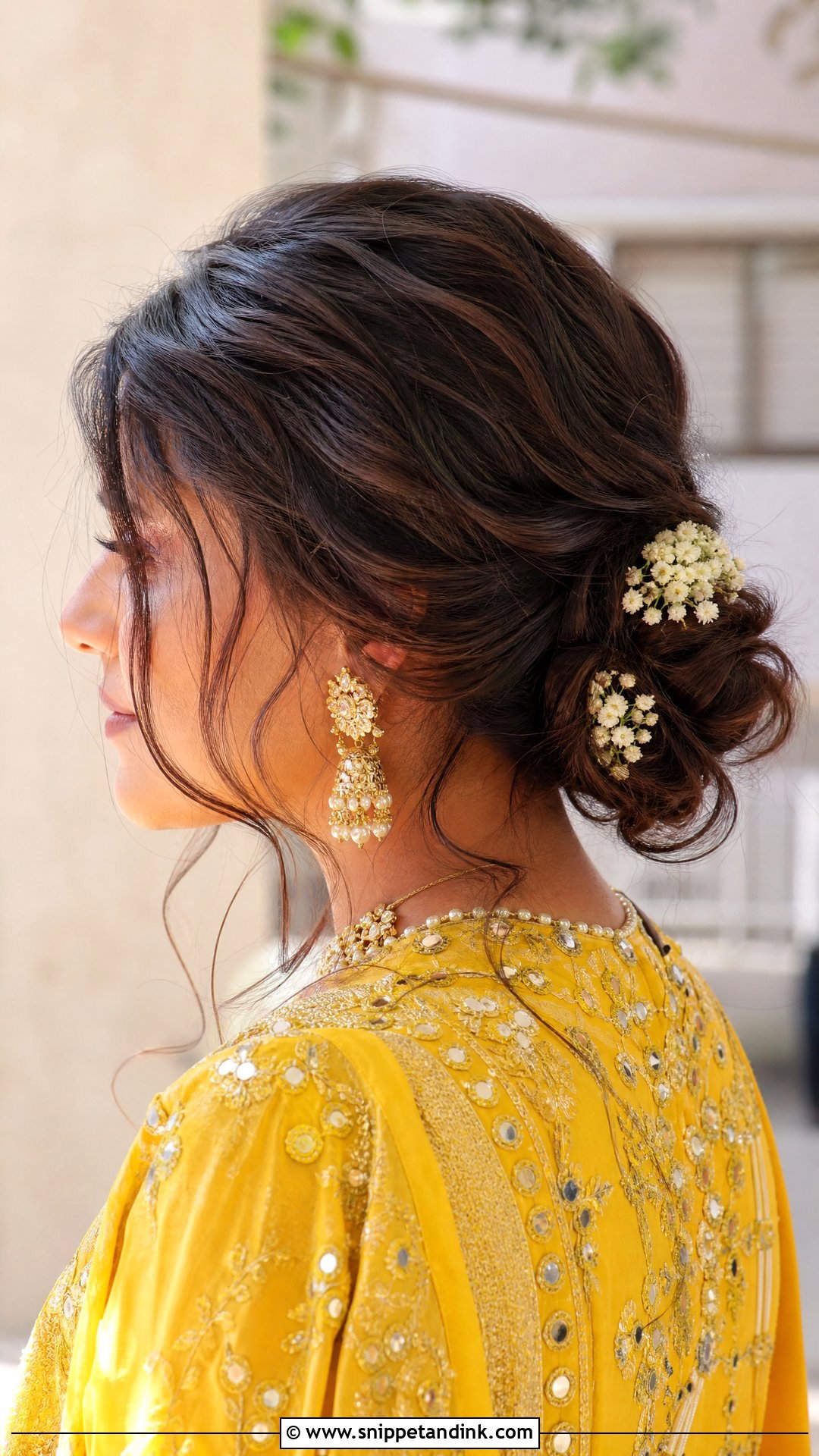 Messy Low Bun With Loose Strands - Snippet and Ink - 20 Haldi Bridal Hairstyle Ideas