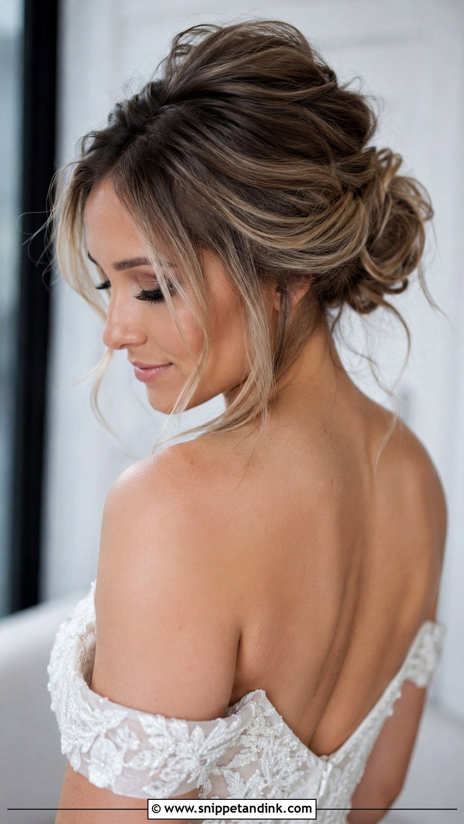 Messy Low Bun With Loose Strands - Snippet and Ink - 20 Cute Bun Hairstyles for Wedding