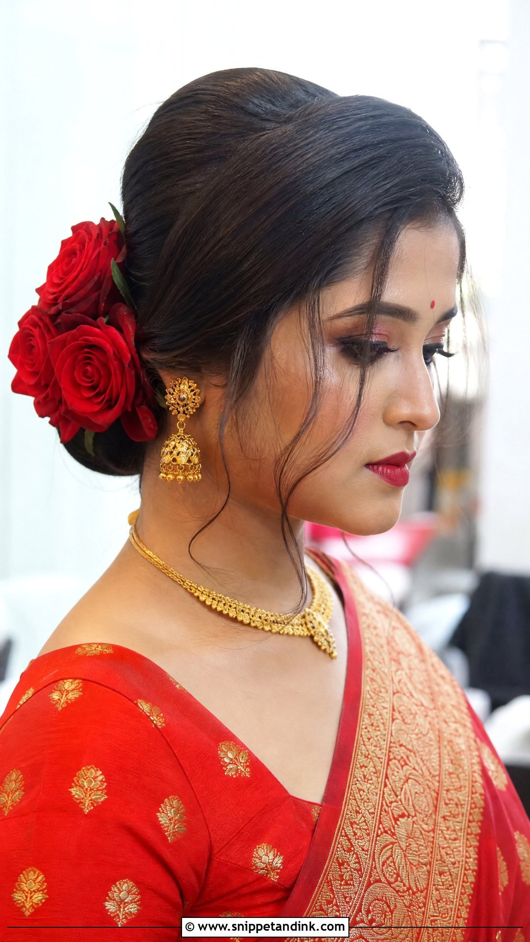 Side Parted Bun With Roses - Snippet and Ink - 20 Bengali Bridal Hairstyle Ideas