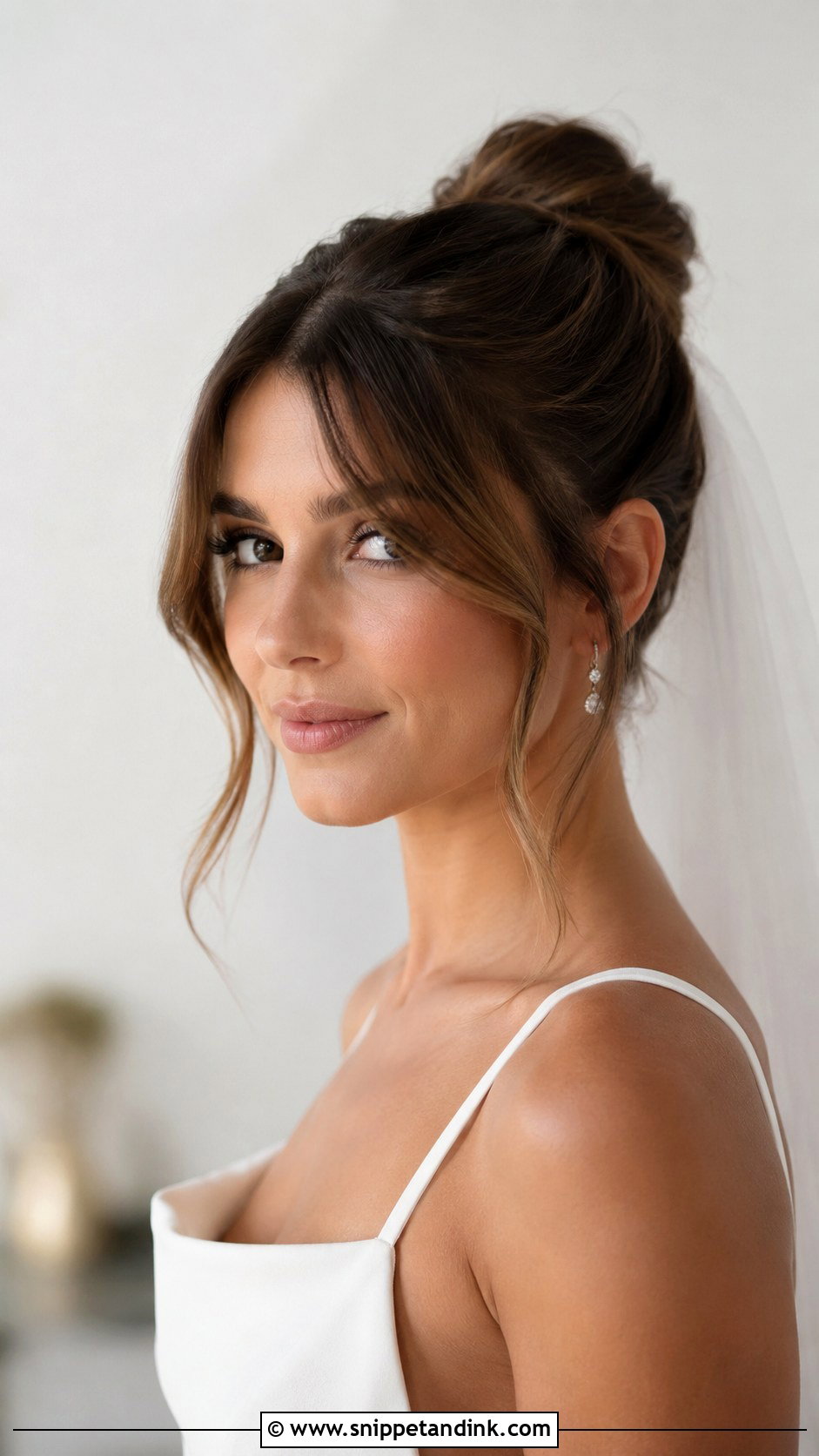 Sleek Bun With Wispy Bangs - Snippet and Ink - 25 Sleek Bun Wedding Hair Ideas