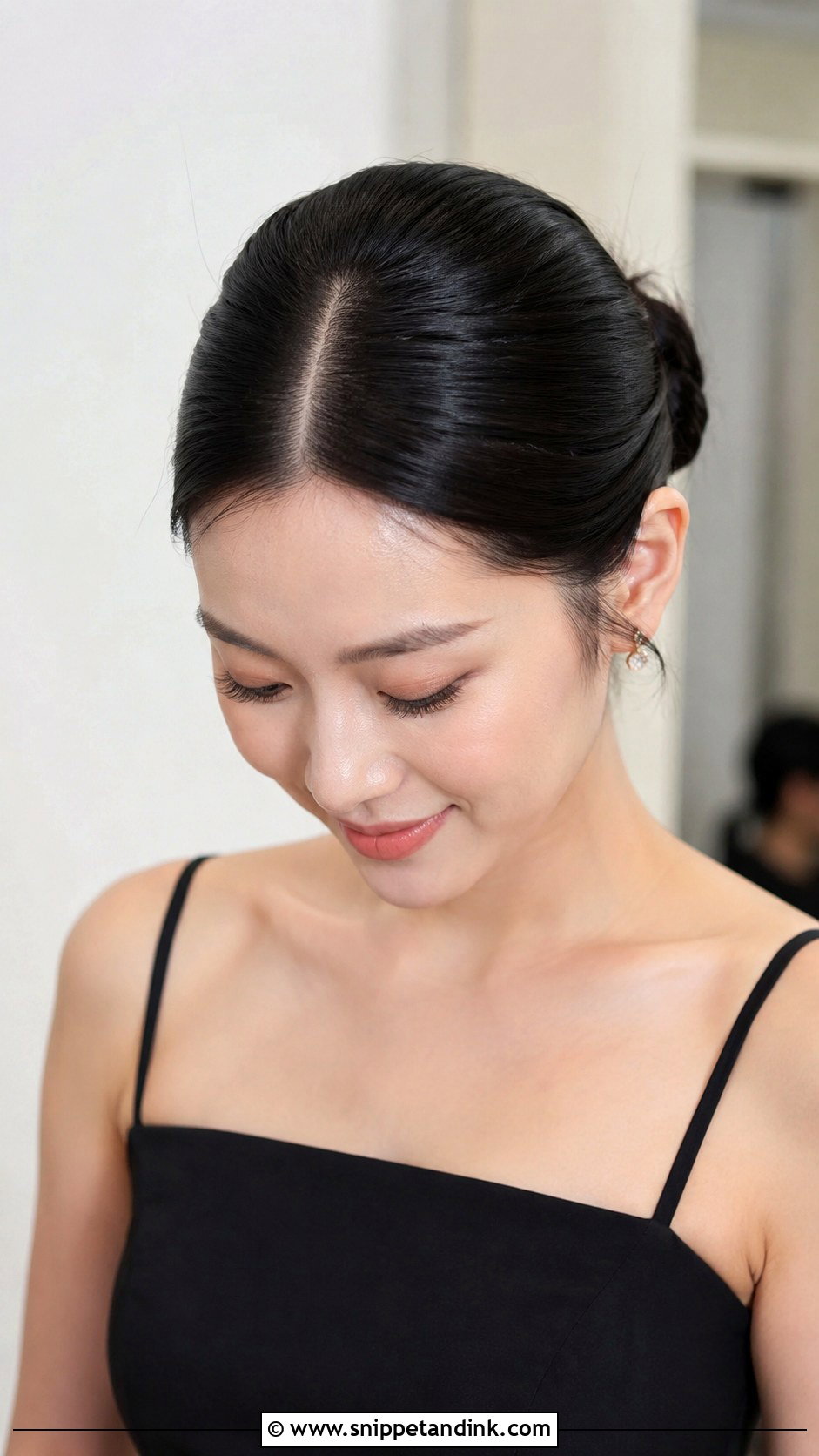Sleek Bun With a Center Part - Snippet and Ink - 20 Bridal Party Hairstyles