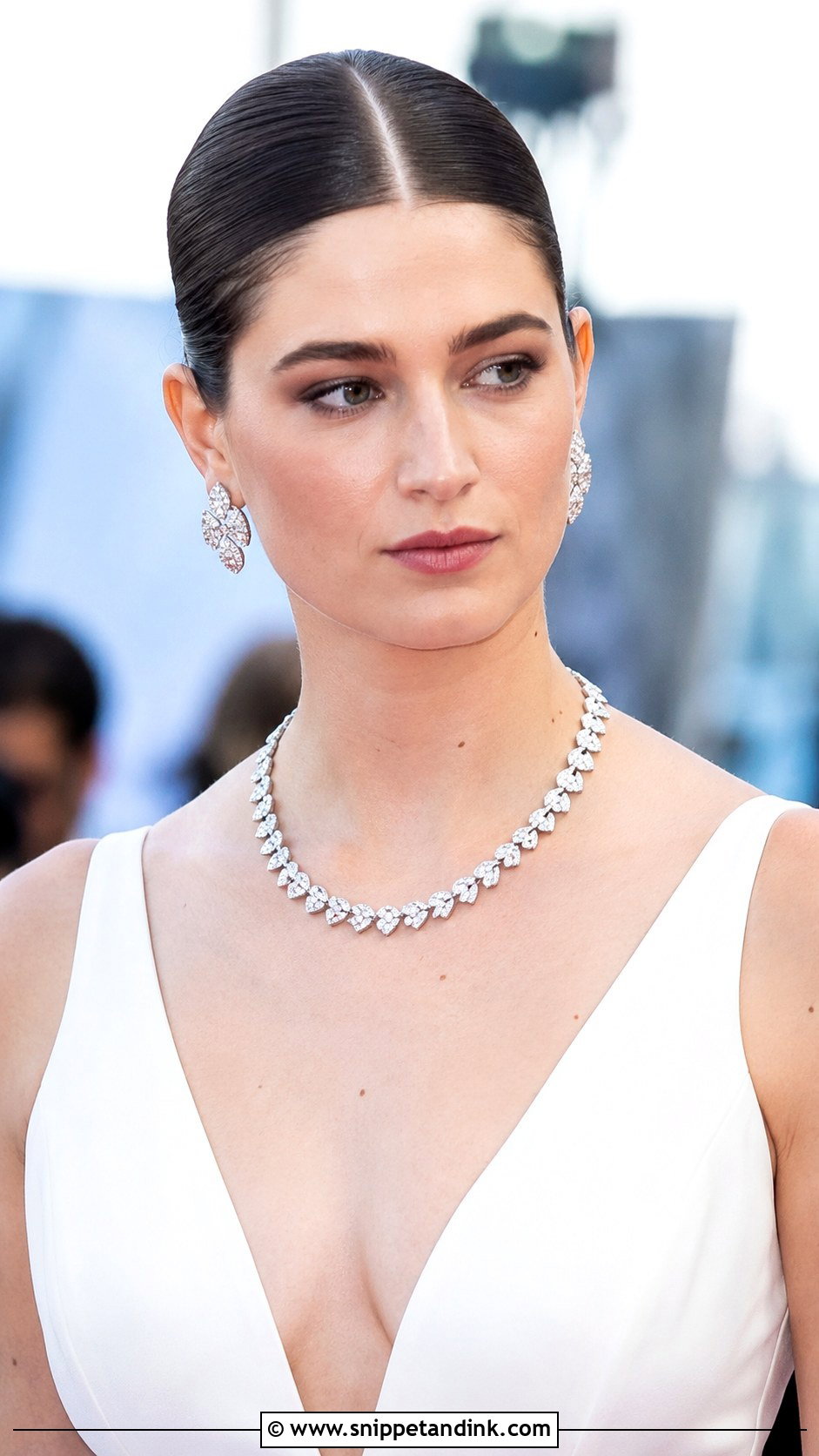 Sleek Bun with Center Part - Snippet and Ink - 25 Glam Bridal Hair Updo Ideas
