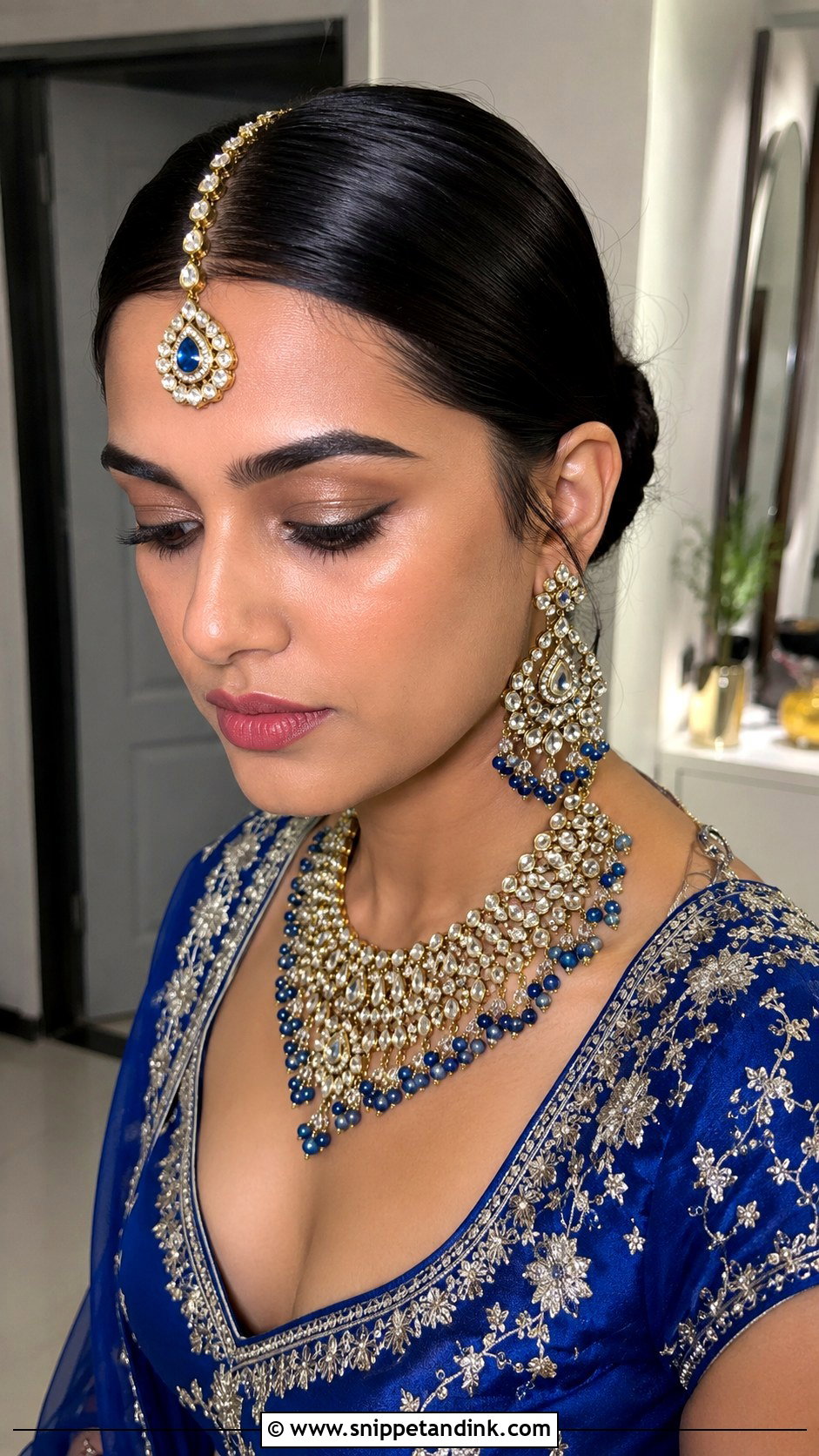 Sleek Center Part Low Bun - Snippet and Ink - 20 Indian Wedding Hairstyles for Round Face