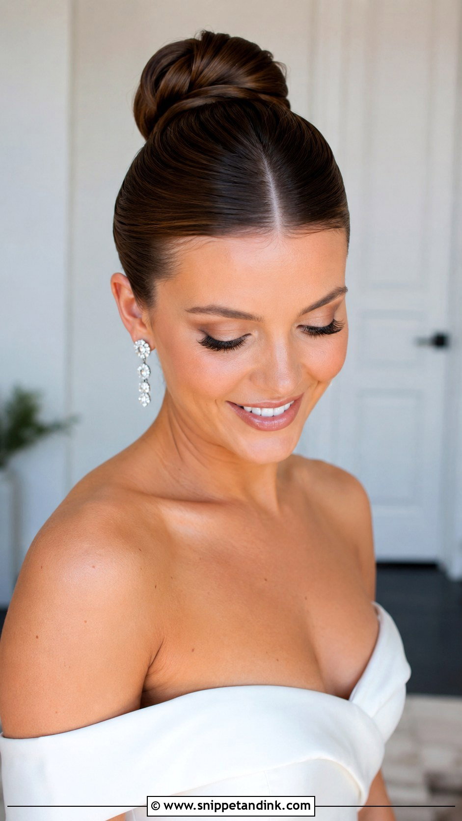 Sleek High Bun With Middle Part - Snippet and Ink - 25 Sleek Bun Wedding Hair Ideas
