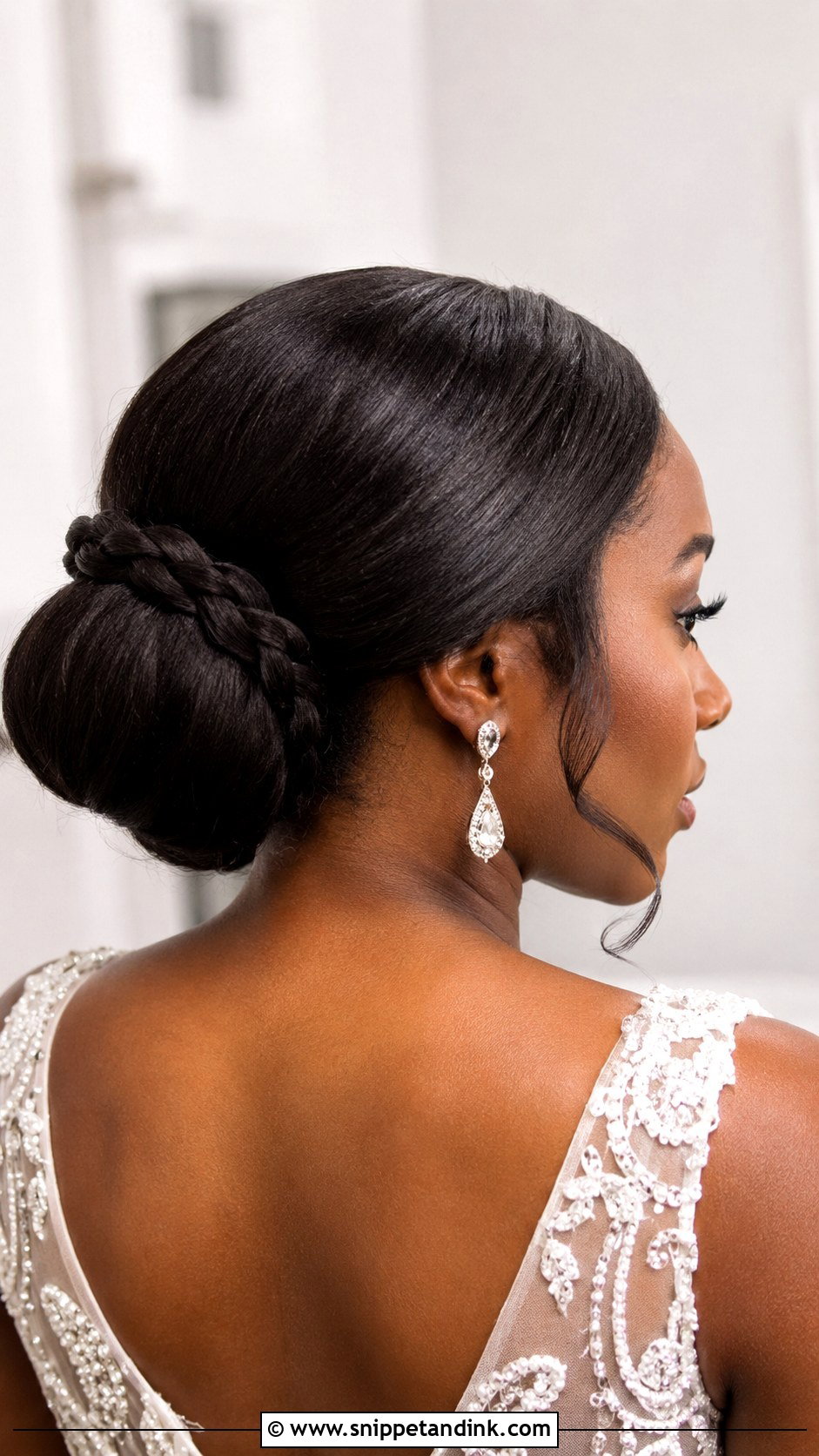 Sleek Low Bun With Braided Detail - Snippet and Ink - 15 Sleek Low Bun Bridal Hair Ideas