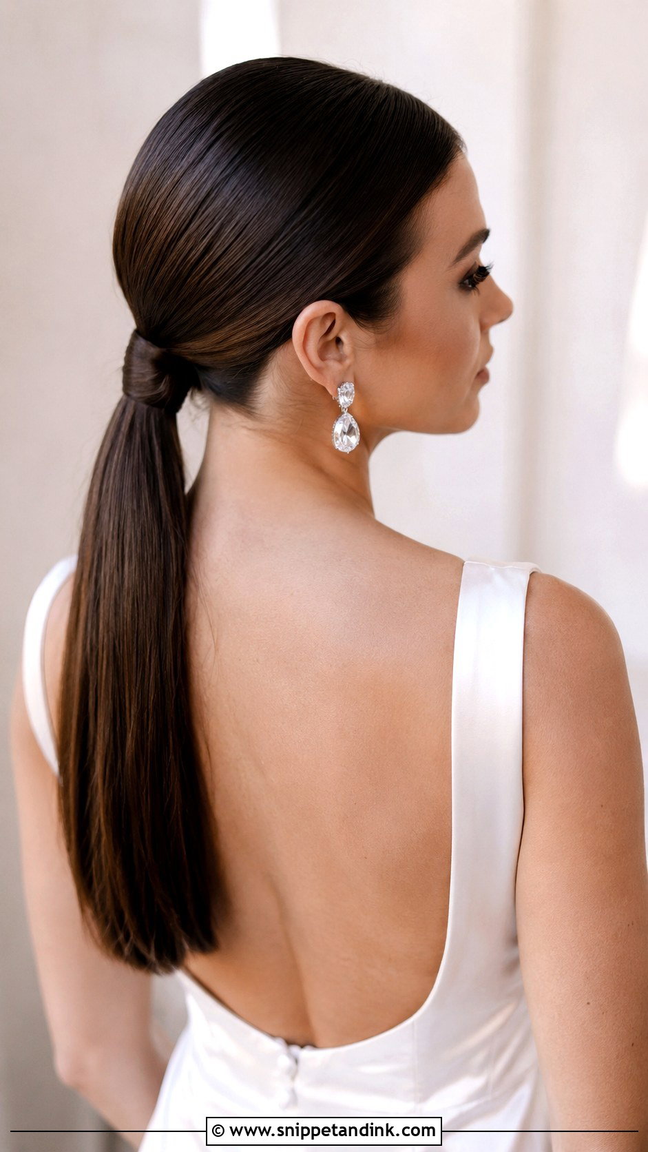 Sleek Low Ponytail With Wrapped Base - Snippet and Ink - 20 Loose Ponytail Wedding Hairstyles