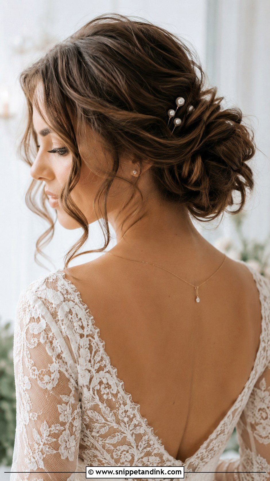 Textured Low Bun With Loose Tendrils - Snippet and Ink - 20 Elegant Updo Wedding Hairstyles